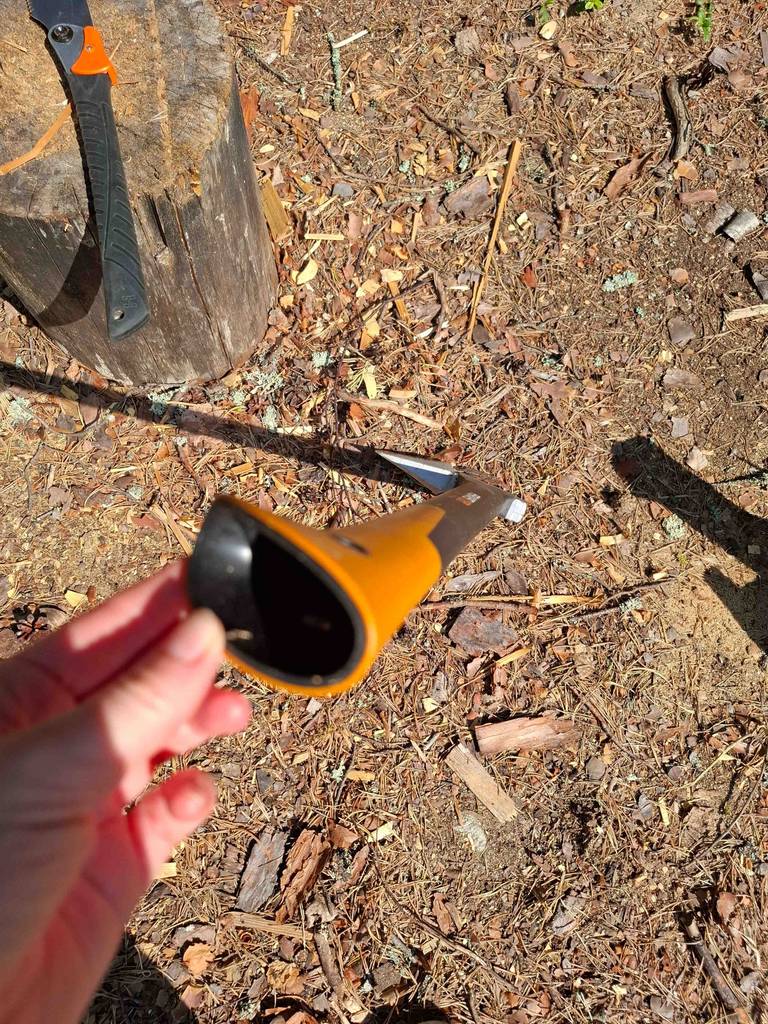 Eine Hand hält den hohlen Griff der Fiskars-Axt im Test in die Kamera.