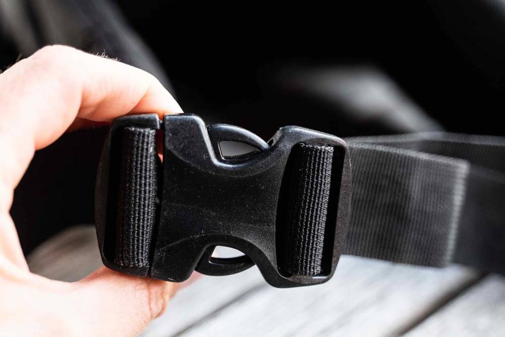 Nahaufnahme eines Verschlusses eines Fotorucksacks im Test von einer Hand gehalten.