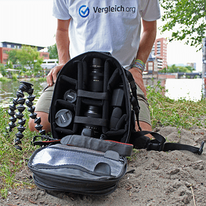 Fotorucksack im Test geöffnet vor vergleich.org-Mitarbeiter am Fluss.