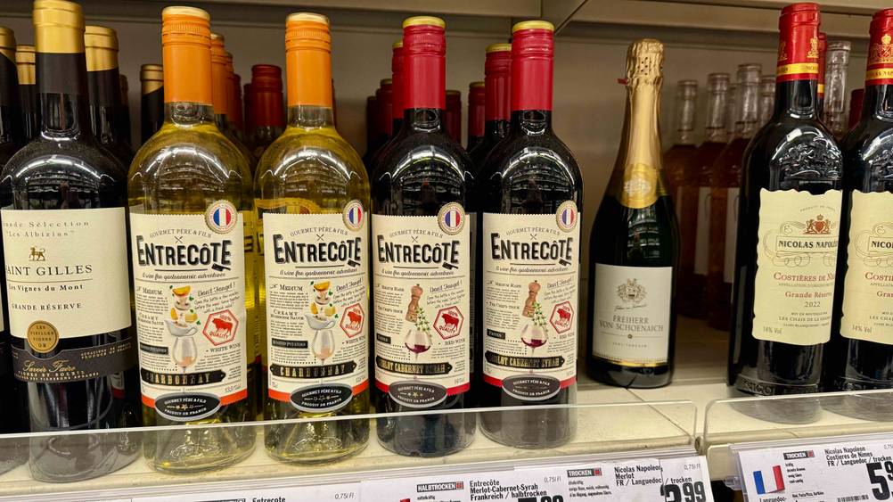 Mehrere Flaschen des französischen Rotweins in einem Verkaufsregal mit anderen Sorten.