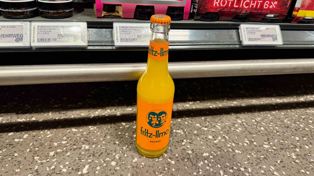 Eine Flasche Fritz-Limo im Test vor einem Verkaufsregal am Boden stehend.