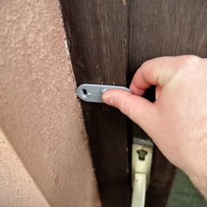 Die Halterung des Senders der Honeywell-Funkklingel wird an einem Türrahmen angebracht.