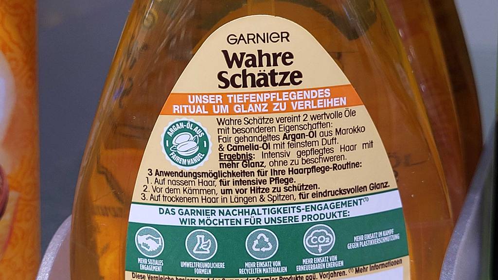 Haaröl im Test: Detailansicht einer goldfarbenen Flasche Garnier Wahre Schätze inklusive Produktbeschreibung.