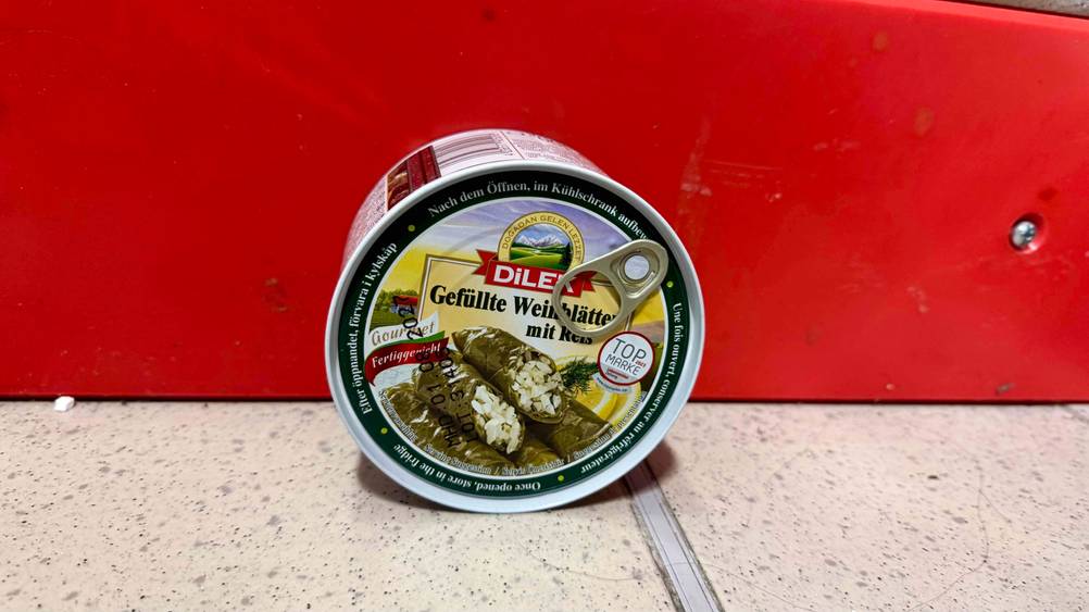 Gefüllte Weinblätter im Test: Eine Dose lehnt an einer roten Leiste.