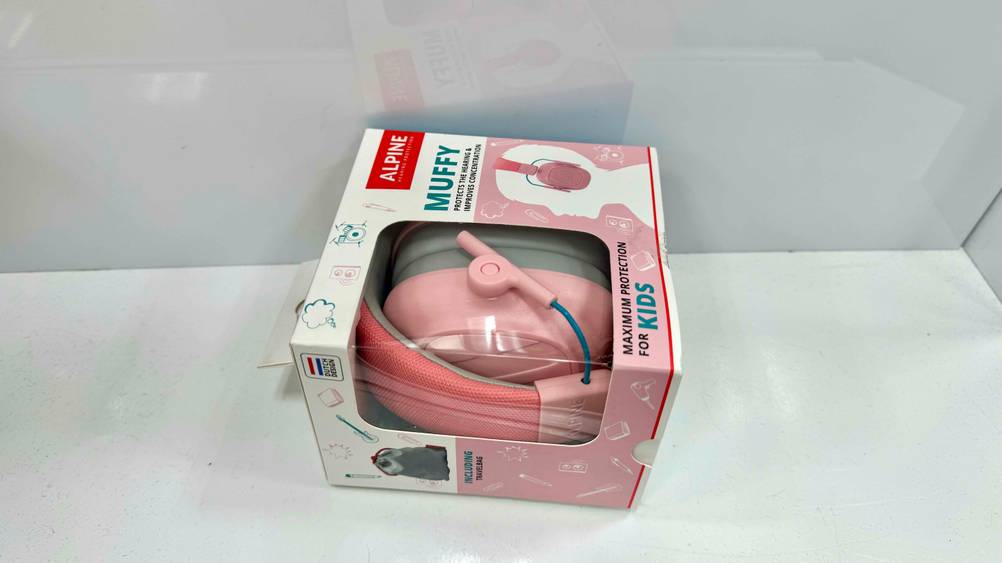 Seitenansicht des orginalverpackten Gehörschutz (Baby) im Test auf einer hellen Fläche liegend.