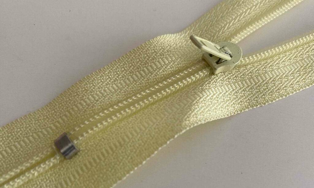 Detailansicht des aufgestellten Läufers an einem gelben Reißverschluss im Test.