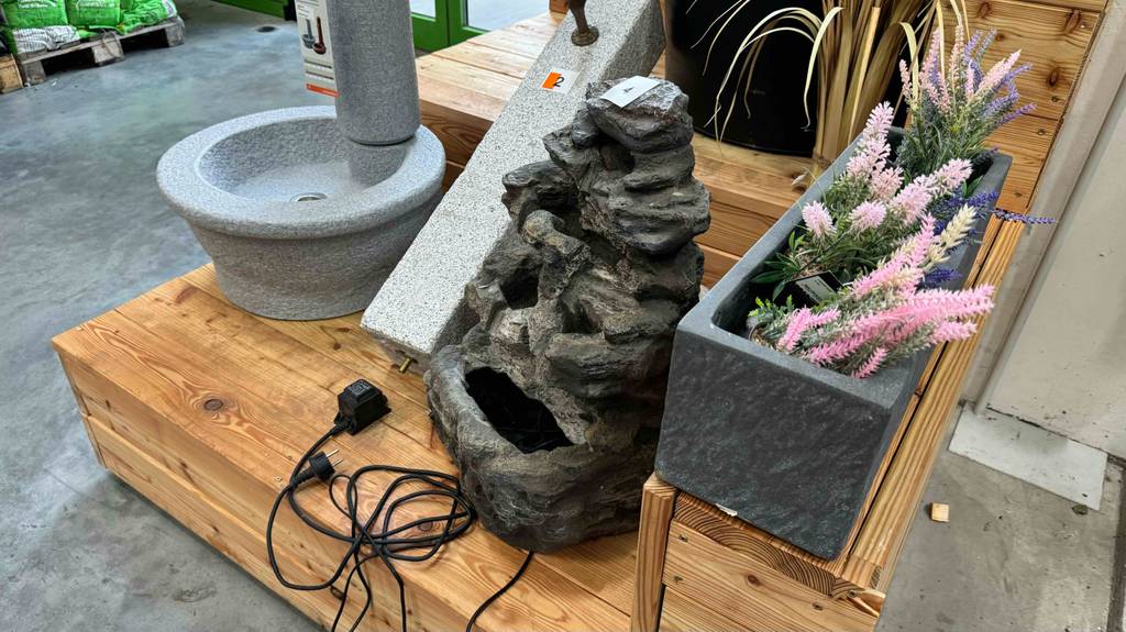 Im Test: Zimmerbrunnen, mehrstöckig im Felsenstein-Design steht neben weiteren Modellen in einem Ausstellungsbereich.