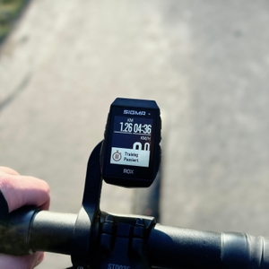 Der Sigma ROX 11.1 EVO Fahrradcomputer ist am Lenker eines Rennrads befestigt. Das Display zeigt die aktuelle Geschwindigkeit und Distanz an.