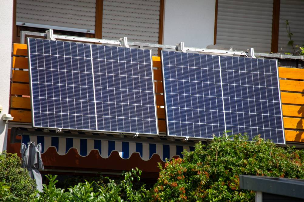 Growatt-Wechselrichter im Test: Ein Balkonkraftwerk mit zwei Panels an einer Balkonbrüstung in der Sonne.