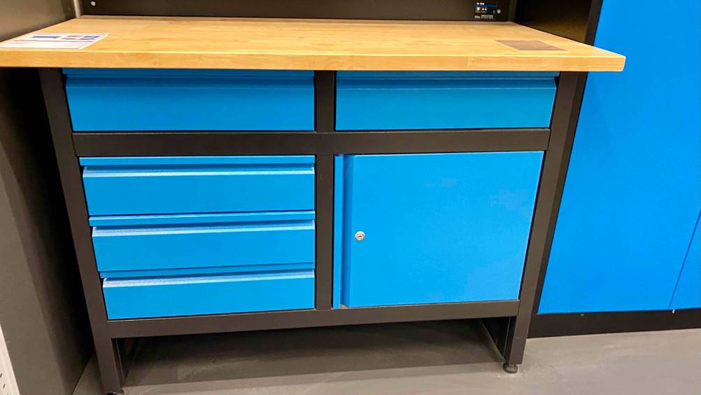Eine blaue Werkbank mit Schubladen und Flächern im Test von vorne.