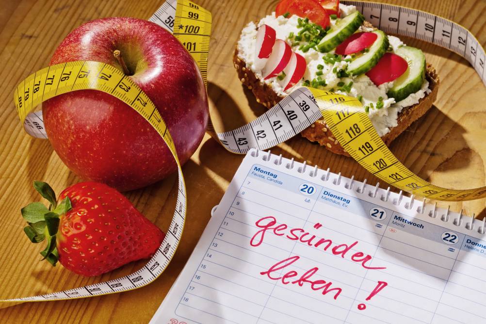 Auf einem Tisch liegt ein Tischkalender, in den in großer Schrift 