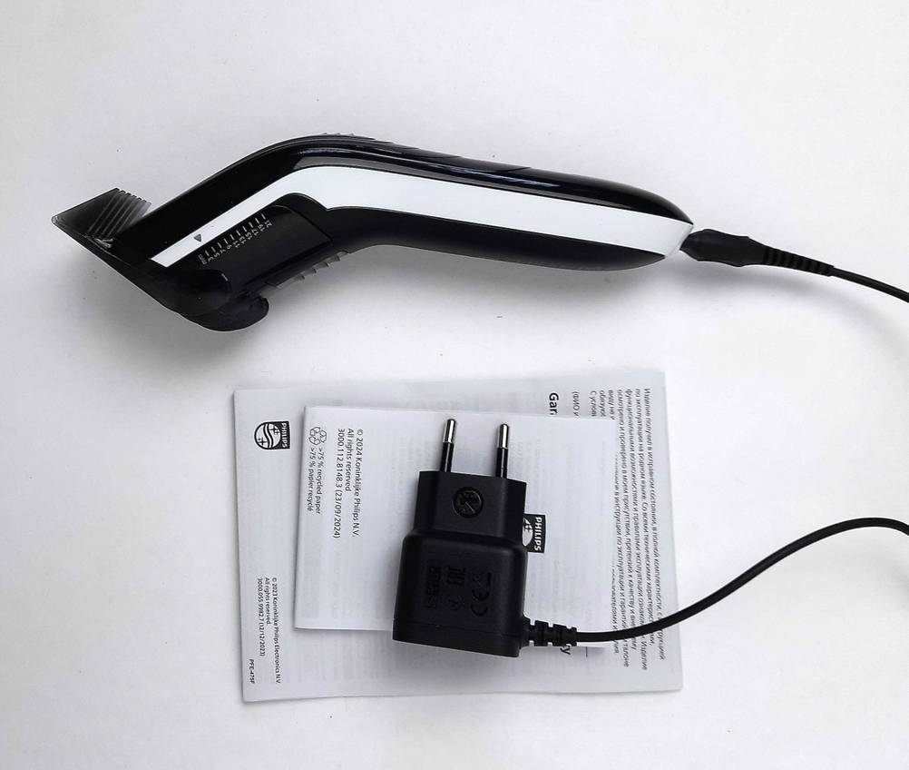 Die Haarschneidemaschine mit Kabel im Test von der Seite mit Kabel und der Gebauchsanweisung.