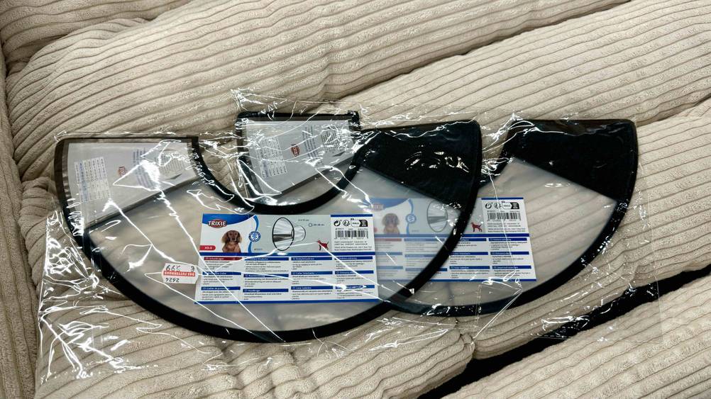 Zwei Halskrausen für den Hund im Test nebeneinander auf einem Polster.