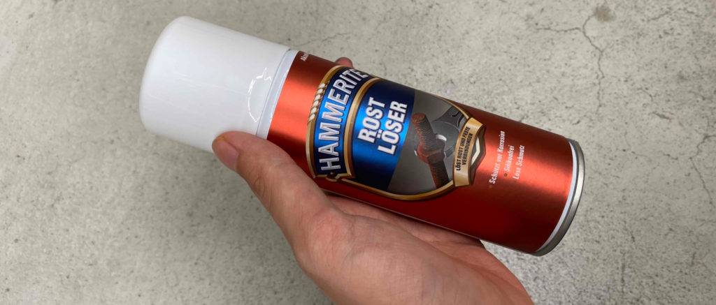 Der getestete Rostlöser wird in der Hand gehalten.