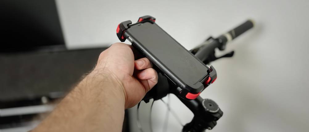 Die Handyhalterung von Lamicall mit Handy darin an einem Fahrrad.