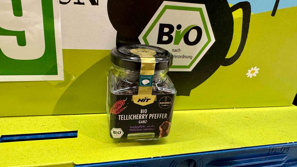 Ein Tellicherry-Pfeffer im Test steht in seiner Dose auf einem grünen Karton im Supermarkt.