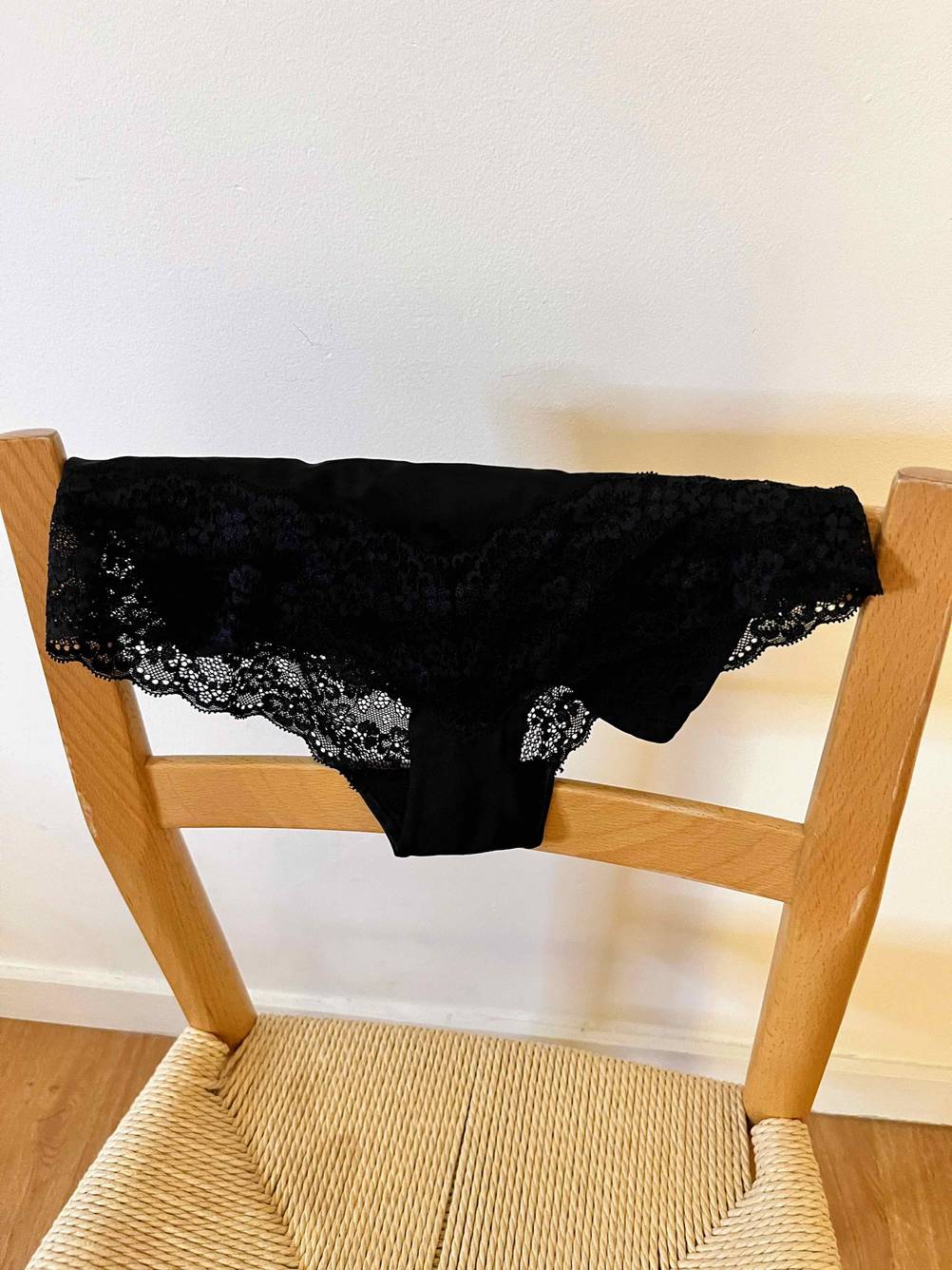 Getestete Shapewear für Damen liegt über der Rückenlehne eines Stuhls.