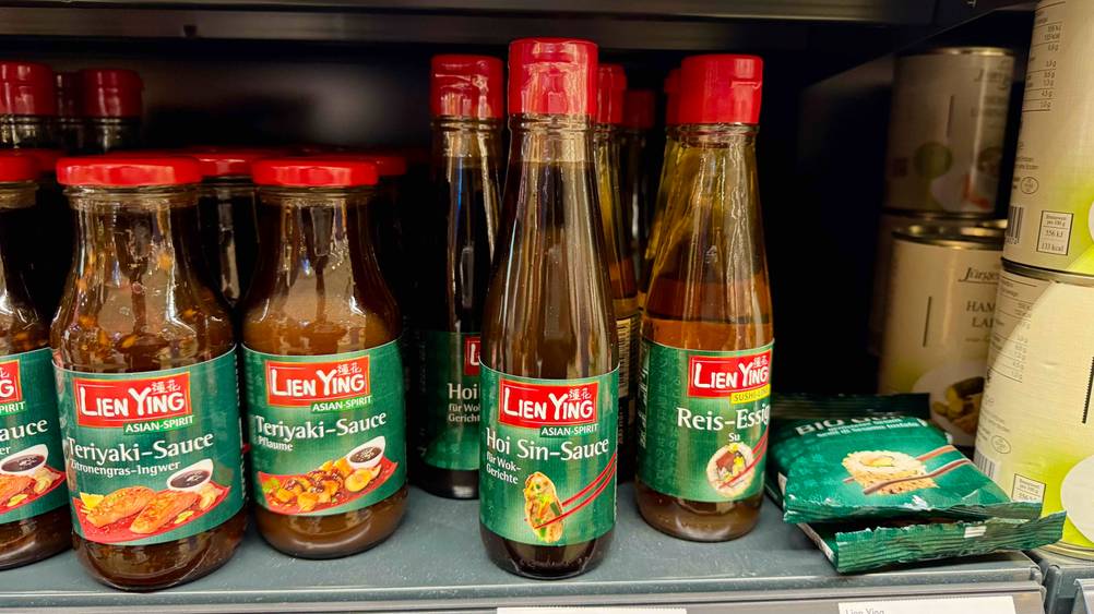 Hoisin-Sauce getestet: Mehrere Flaschen stehen in einem Verkaufsregal.