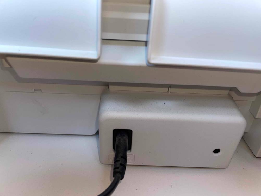 Nahaufnahme des Stromanschlusses auf der Rückseite eines getesteten HP-Druckers.