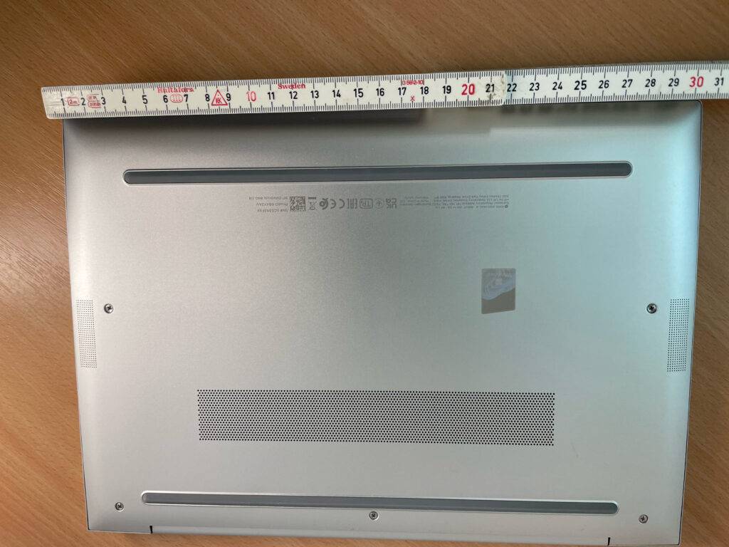 Unterseite eines getesteten Laptop bis 700 Euro, darüber ein Meterstab zur Breitenmessung.