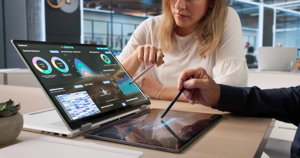 Zwei Kollegen sitzen um ein großes Omnibook-Flip von hp und diskutieren über eine Grafik.