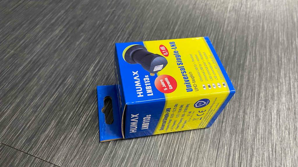 Single-Universal-LNBs im Test: eine blau-gelbe Packung inklusive UHD-tauglichen Single-Universal-LNB113s liegt auf einem grauen Boden.