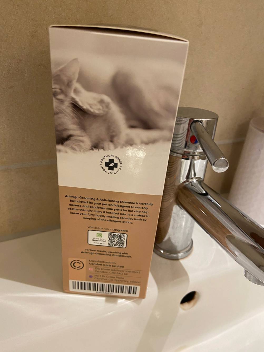 Seitenansicht der Verpackung des getesteten Hundeshampoo (weißes Fell) mit Strichcode auf einem Waschbeckenrand.