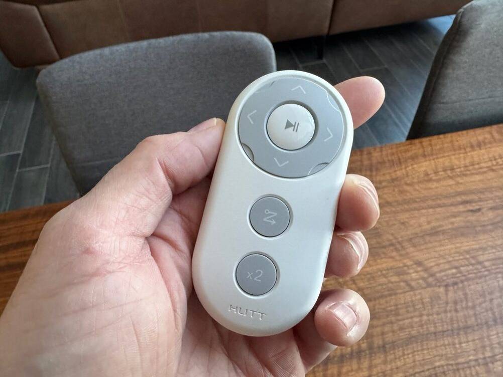 Eine Hand hält die Fernbedienung des Hutt DDC55 in der Hand