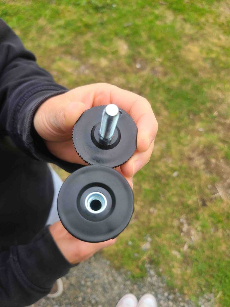 Nahaufnahme des Gewindes und der Schraube am Fuß für die Höheneinstellung des getesteten Tischbeins aus Metall.