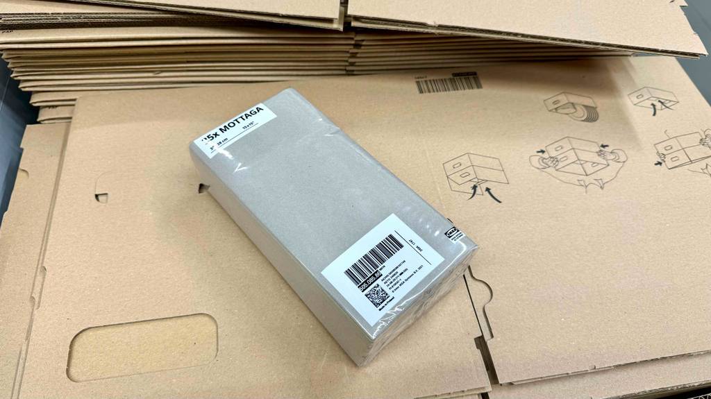 Eine Packung Papierhandtücher liegt zum Testen auf einem Stapel Kartons.