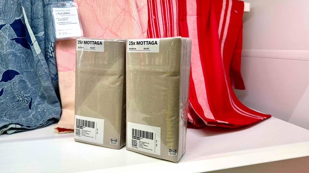 Papierhandtücher im Test: zwei Packungen stehen nebeneinander vor Geschirrtüchern.