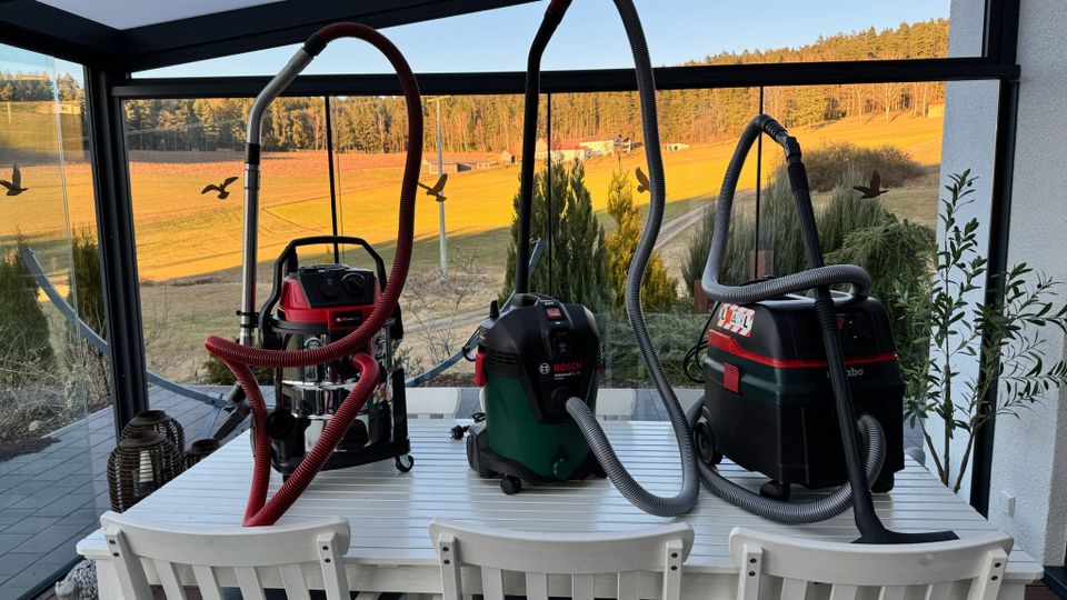 Drei Industriestaubsauger stehen nebeneinander auf einem Tisch