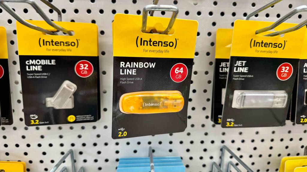 Getestet: Intenso USB-Sticks, eingeschweißt in ihren Verpackungen, hängen an einem Verkaufsstand.