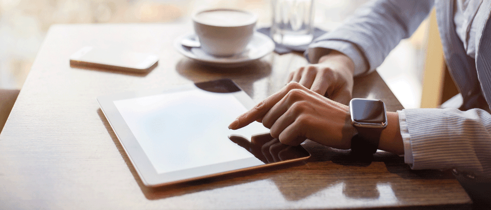 Mann mit Tablet und Smart-Watch