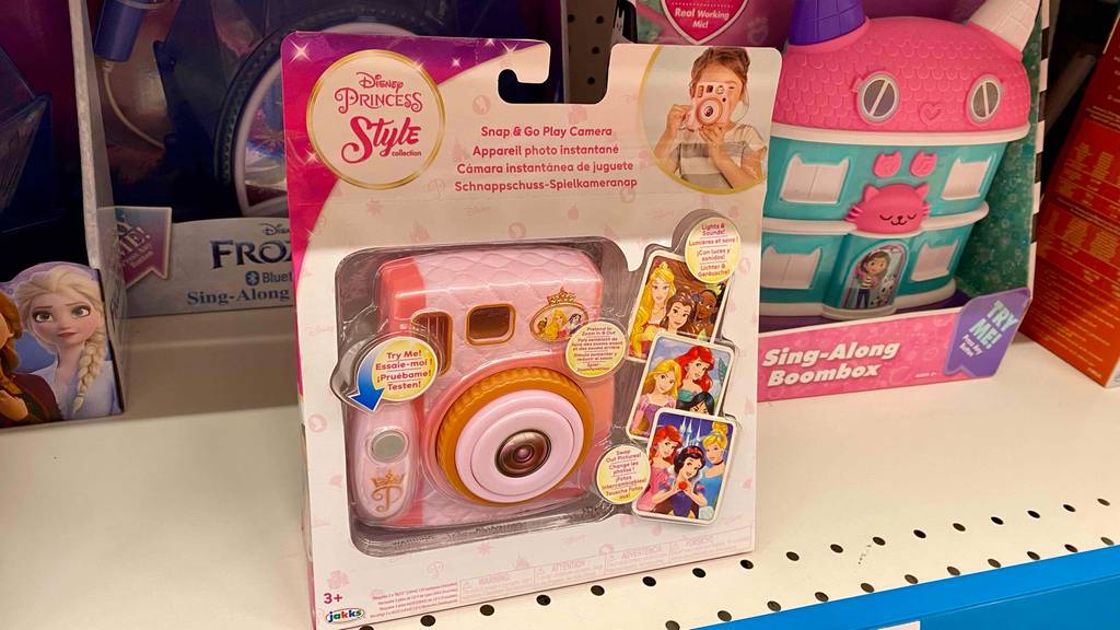 Eine Rosa Kinderkamera Disney Princess steht in der Originalverpackung auf einem Verkaufsregal.