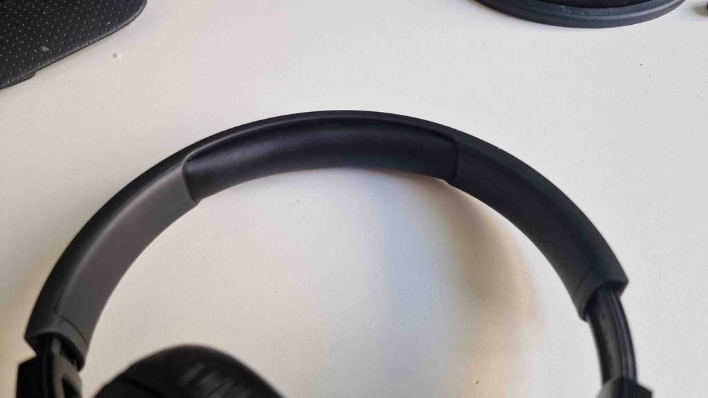 Auf dem Tisch liegt ein getesteter JBL-Bluetooth-Kopfhörer.