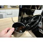 Kaffee wird aus der Severin KA 9250 Thermoskanne in eine schwarze Tasse eingeschenkt. Beide Hände halten Kanne und Tasse.