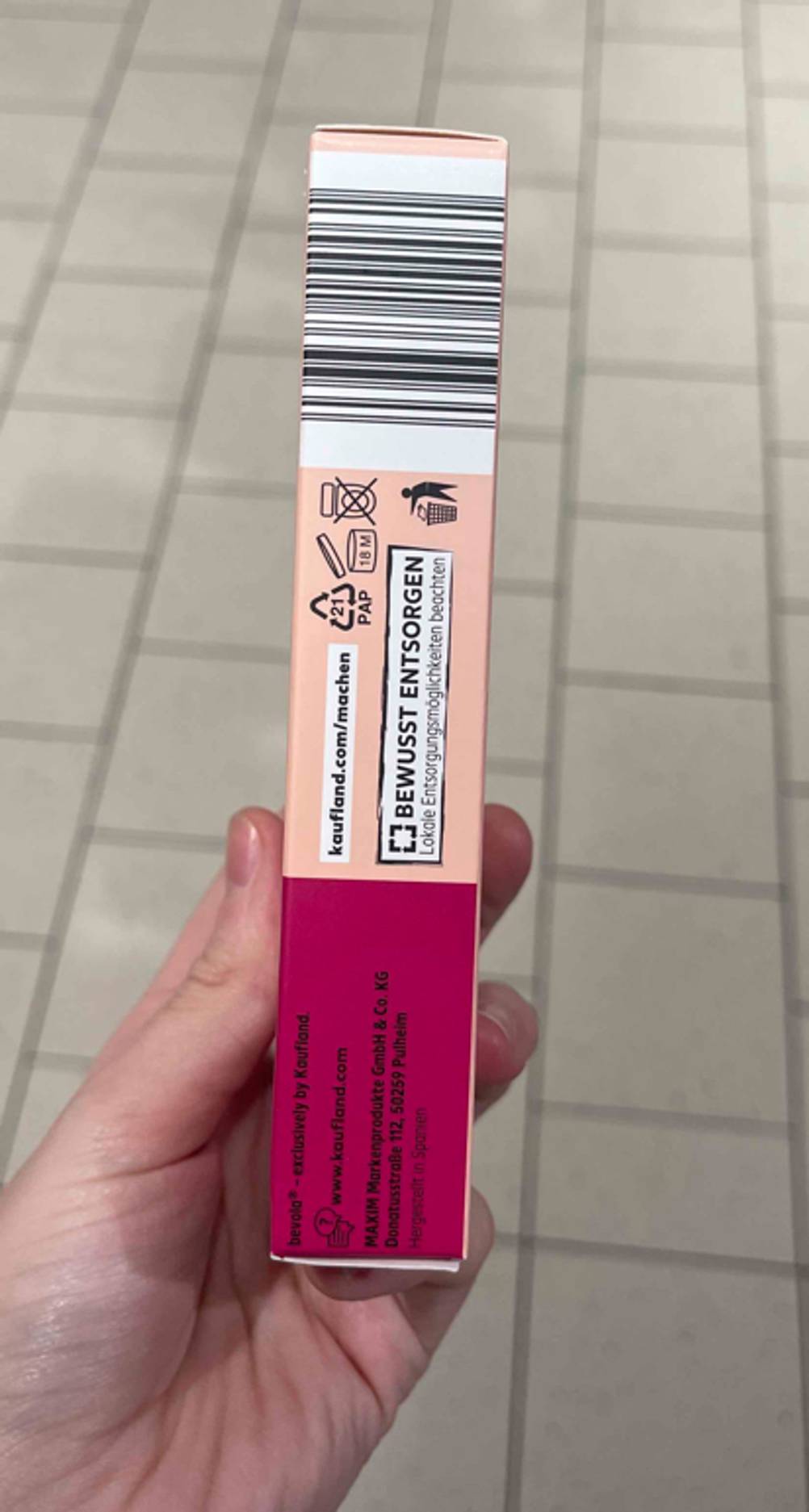 Seitenansicht der Verpackung der getesteten Kaltwachsstreifen Gesicht von einer Hand gehalten.