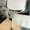 Wasserdampf steigt während des Brühvorgangs aus der Bosch Tassimo My Way 2 auf. Ein Glas steht unter dem Auslauf.