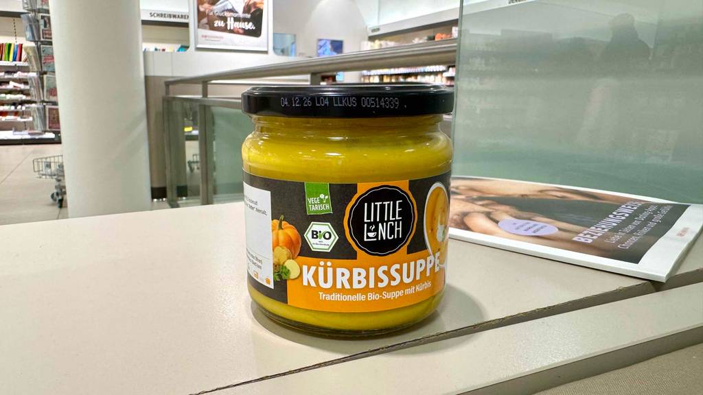 Getestet: Eine Little-Lunch-Kürbissuppe im Glas steht neben einer Zeitschrift in einem Drogeriemarkt.