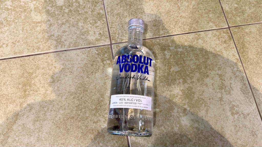 Eine Flasche Vodka Absolut im Test liegt auf dem Boden.