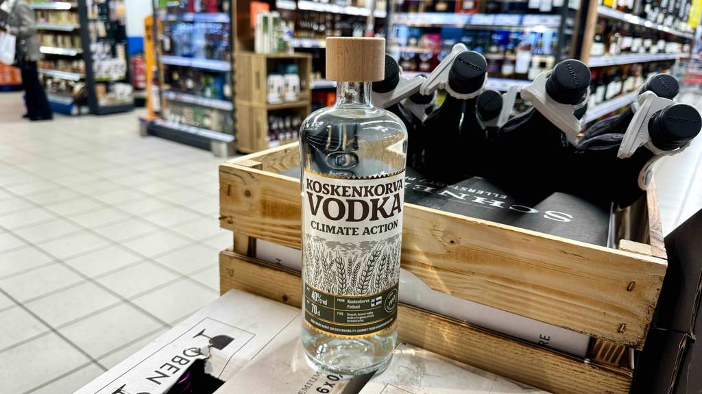 Koskenkorva-Vodka im Test: Eine Flasche steht vor weiteren Flaschen mit Alkohol auf einem Karton im Geschäft.