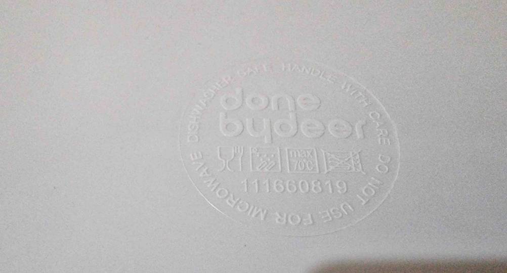 Nahaufnahme der Einprägung mit Logo auf der Rückseite eines getesteten Kindertellers.