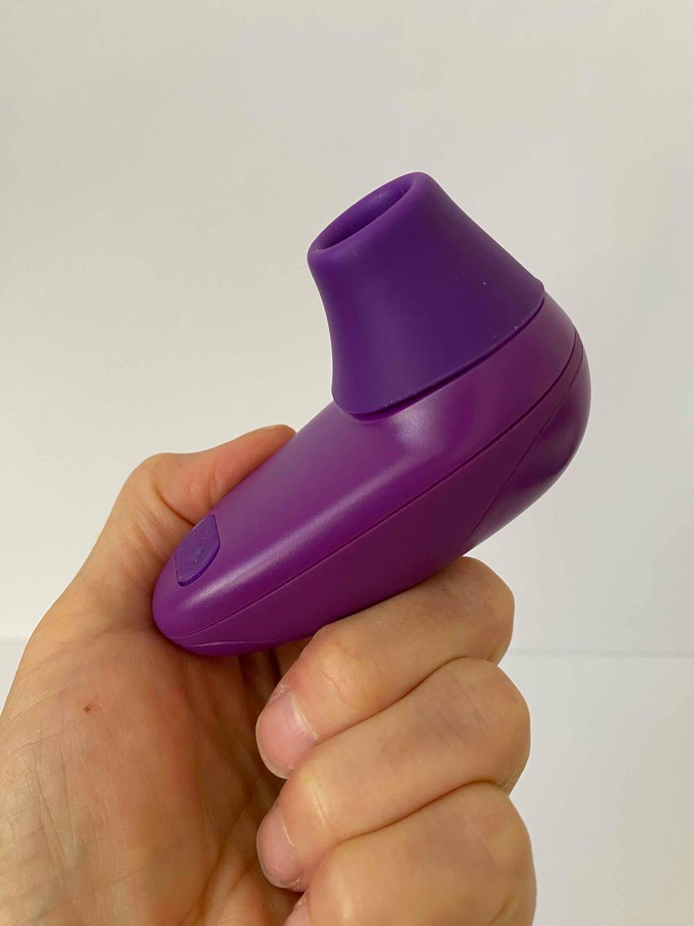 Eine Hand hält den Klitorissauger im Test hoch.