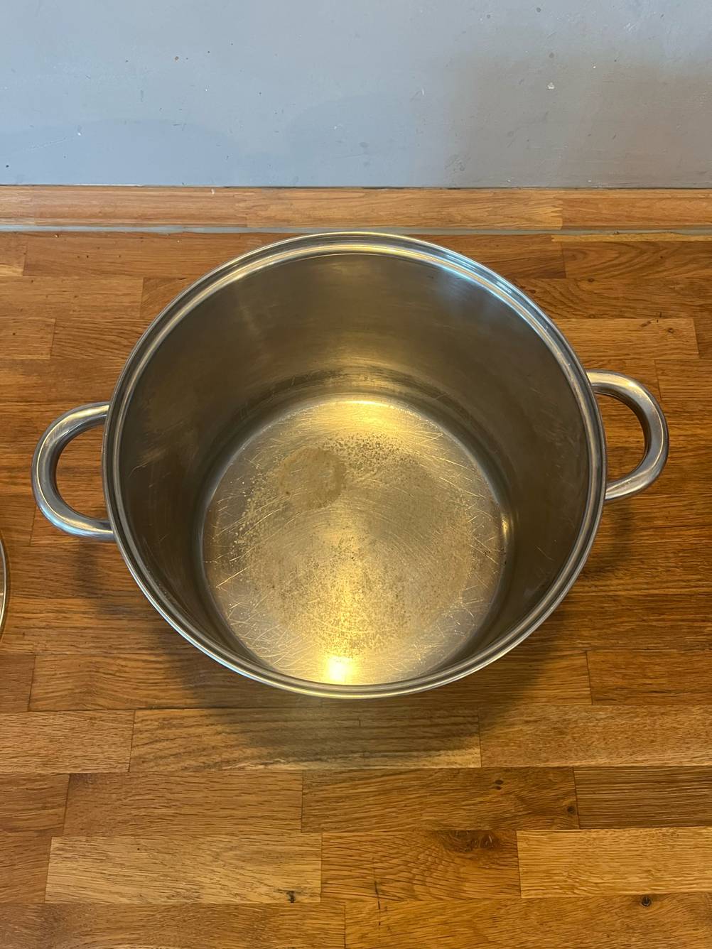 Ein getesteter 15-Liter-Kochtopf von oben ohne Deckel auf einer Holzfläche.