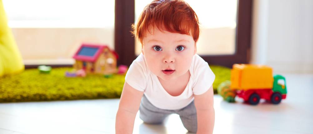 cute toddler baby crawling on the floor at home
