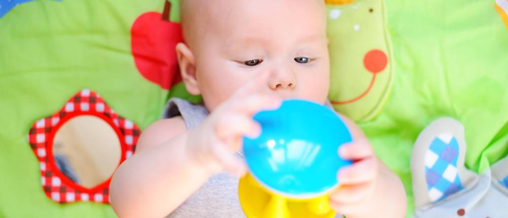 Little baby play with bright toy