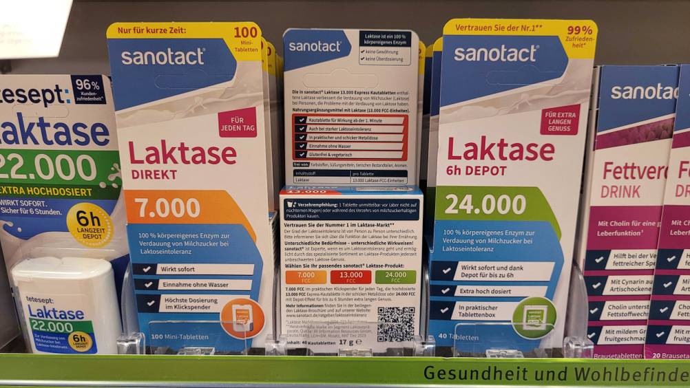 Eine Packung der Laktase-Tabletten im Test steht neben anderen Produkten in einem Regal.