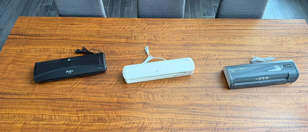 Drei Laminiergeräte-A3 liegen nebeneinander auf einem Tisch