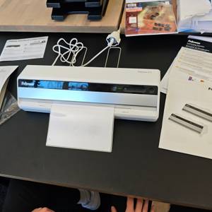 Eine DIN-A4-Folie wird im Fellowes Saturn 3i laminiert.